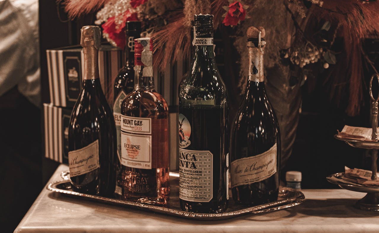 A sophisticated arrangement of premium wines and spirits at a bar in Milan, Italy, showcasing luxurious bottles in a warm setting.